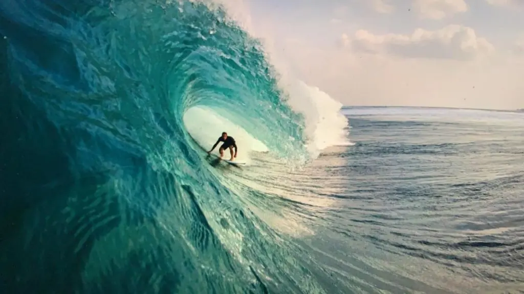 Surfer deep in a turquoise barrel at Bombies, Rote Island