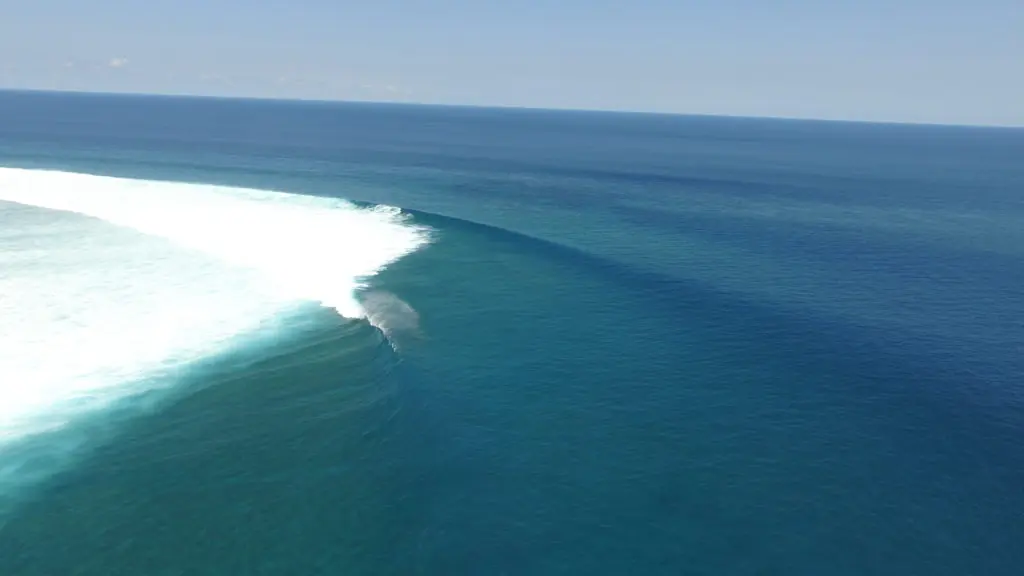 Aerial view of a long wave breaking over the reef in Rote Island